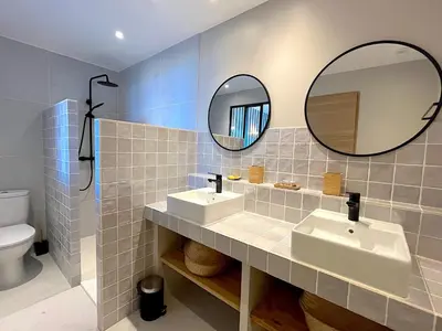 a bathroom with two sinks and a mirror at Villa San Joseph in Cargèse