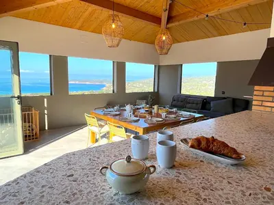 a dining room with a table with food on it at Villa San Joseph in Cargèse