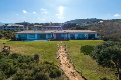 a house in a field with a fence at Villa HAPPY DAYS in Pietrosella