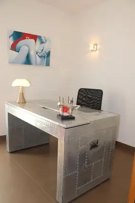 a silver desk with a chair and a lamp at Villa HAPPY DAYS in Pietrosella