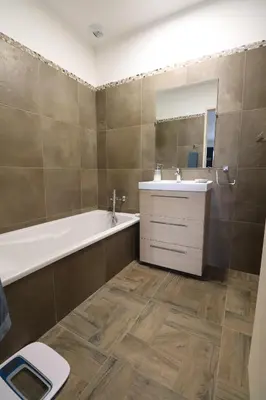 a bathroom with a tub and a sink and a toilet at La Maison de vacances à Ajaccio- Proche plage et aéroport- Extérieur privatif avec barbecue in Ajaccio