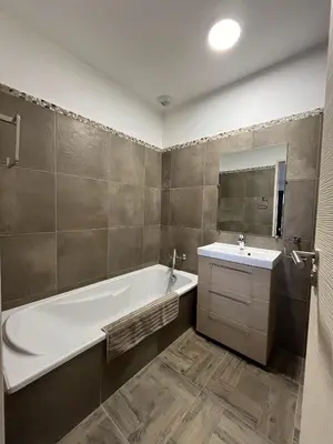 a bathroom with a bath tub and a sink at La Maison de vacances à Ajaccio- Proche plage et aéroport- Extérieur privatif avec barbecue in Ajaccio