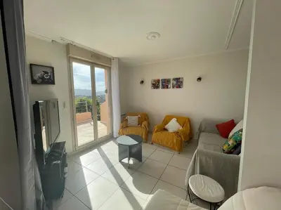 a living room with a couch and a table at Villa Bell'am Corse in Porto-Vecchio