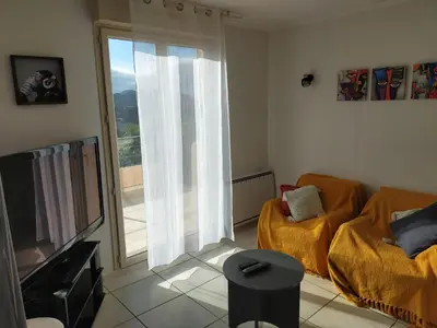 a living room with a couch and a television at Villa Bell'am Corse in Porto-Vecchio
