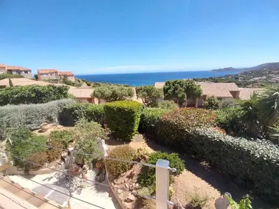 a garden with a view of the ocean at Villa Bell'am Corse in Porto-Vecchio