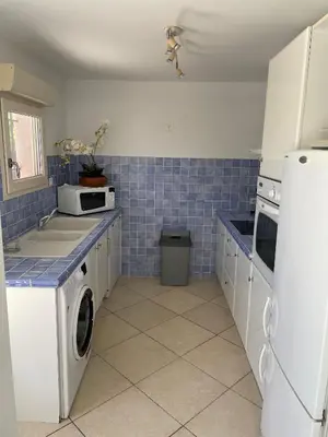 a kitchen with a washer and dryer in it at Villa Bell'am Corse in Porto-Vecchio