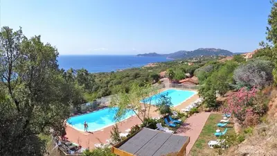 an image of a swimming pool with the ocean in the background at Villa Bell'am Corse in Porto-Vecchio