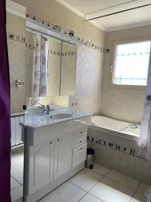 a white bathroom with a sink and a bath tub at Villa Bell'am Corse in Porto-Vecchio