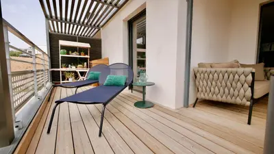 a balcony with a chair and a couch at Appartamentu A Leccia in Grosseto-Prugna