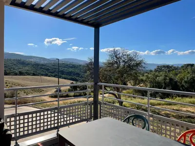 a balcony with a view of the mountains at Appartamentu A Leccia in Grosseto-Prugna