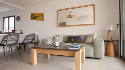 a living room with a couch and a table at Appartamentu A Leccia in Grosseto-Prugna