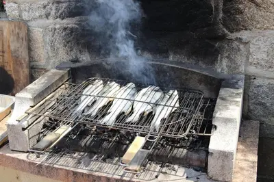 a bunch of chickens cooking on a grill at Grand appartement T4 - piscine - vue féérique in Propriano