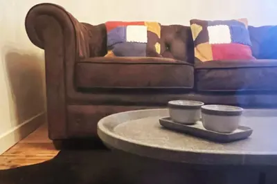 a coffee table in a living room with a couch at Appartement prestige, cour Paoli in Corte