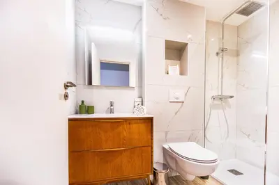 a bathroom with a sink and a toilet and a shower at Casamea - T3 U Benestà in Talasani