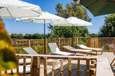 a group of chairs and umbrellas on a deck at Casamea - T3 U Benestà in Talasani