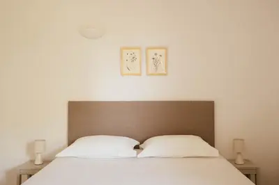 a bedroom with a bed with two white pillows at Les Hauts de Santa Giulia in Porto-Vecchio