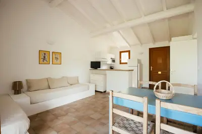 a living room with a couch and a table at Les Hauts de Santa Giulia in Porto-Vecchio