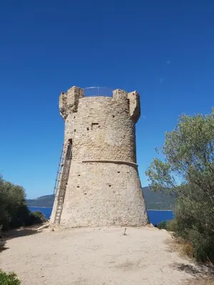 a tall brick tower sitting on top of a beach at Le Francorsicat in Serra-di-Ferro
