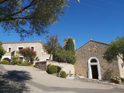 a stone church with a cross on top of it at Le Francorsicat in Serra-di-Ferro