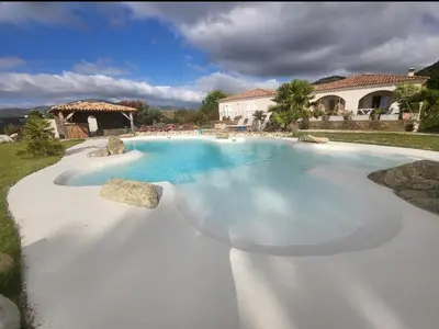 a swimming pool with blue water and a gazebo at VILLA luxueuse privée avec piscine lagon in Calenzana