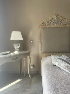 a bedroom with a large bed with a teddy bear on it at VILLA luxueuse privée avec piscine lagon in Calenzana