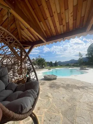 a park with a bench and flowers in a field at VILLA luxueuse privée avec piscine lagon in Calenzana