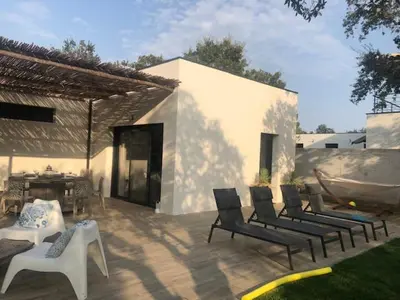a patio with a group of chairs and a table at LES VILLAS LECCI E MARE in Zonza