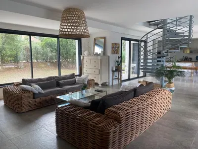 a living room with two couches and a glass table at LES VILLAS LECCI E MARE in Zonza