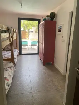 a room with a room with a door to a patio at LES VILLAS LECCI E MARE in Zonza