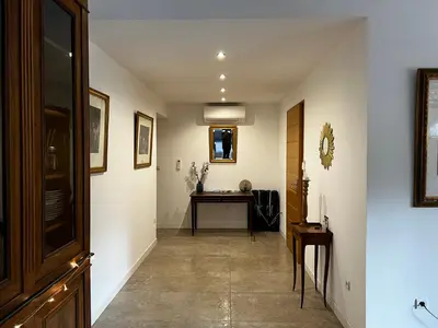 a hallway with a table and a desk in a room at LES VILLAS LECCI E MARE in Zonza