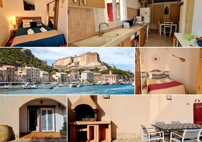 a small bedroom with a bed with slippers on it at Appartement Kallisté, Logements avec vue citadelle de Bonifacio in Bonifacio