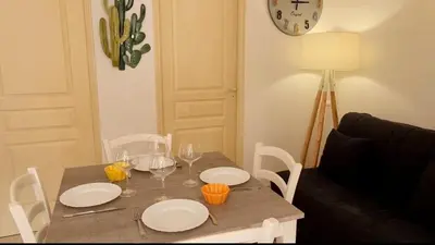 a table with three glasses of wine on it at Appartement Kallisté, Logements avec vue citadelle de Bonifacio in Bonifacio
