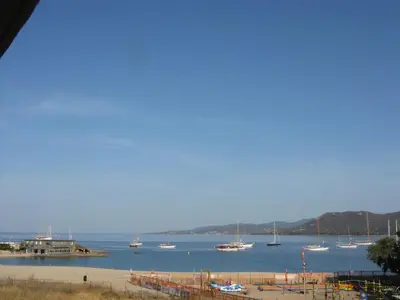 a group of boats in the water near a harbor at Hôtel Beach in Propriano