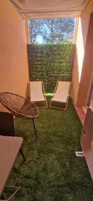 a balcony with two beds and a table and chairs at Casa Ghjulia St-Cyprien Rétro Chic in Lecci