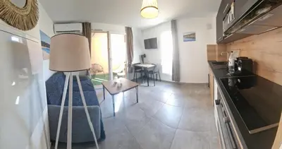 a living room with a couch and a table at Casa Ghjulia St-Cyprien Rétro Chic in Lecci