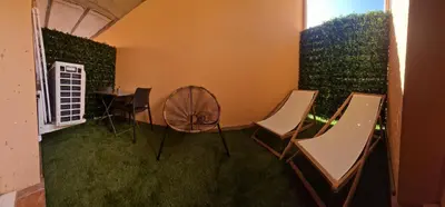 a room with chairs and a table and a fan at Casa Ghjulia St-Cyprien Rétro Chic in Lecci