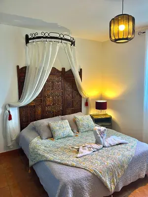 a bedroom with a large bed with a canopy at Domaine Victoria in SantʼAntonino