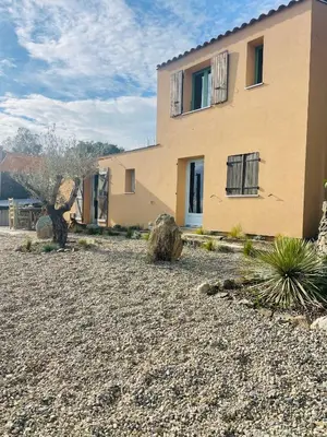 a house with a gravel yard in front of it at Maison Murato in San-Giuliano