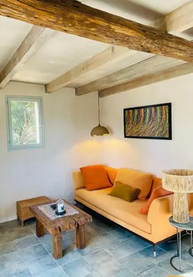a living room with a couch and a table at Maison Murato in San-Giuliano