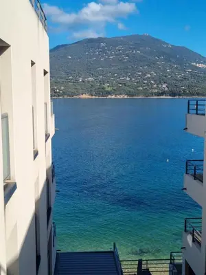 a view of a large body of water between two buildings at MAGNIFIQUE APPARTEMENT LES PIEDS DANS L'EAU PROPRIANO in Propriano