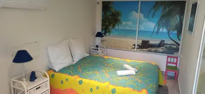 a bedroom with a bed with a view of the beach at Villa classée 5* 7 chambres piscine spa plage à 5' in Sainte-Lucie de Porto-Vecchio