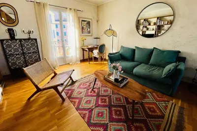 a living room with a green couch and a table at F3 de charme centre ville Ajaccio in Ajaccio