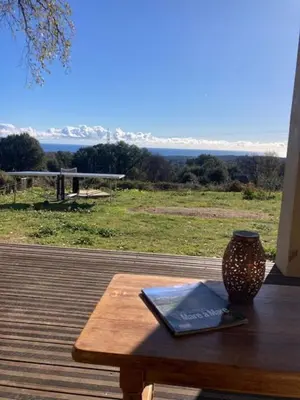 a wooden table with a book and a vase on it at DOLCE VITA-Calme-Vue Mer in Chiatra