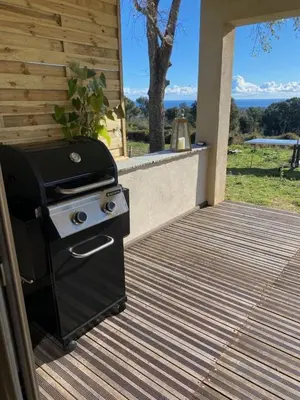 a grill on a deck with a view of the ocean at DOLCE VITA-Calme-Vue Mer in Chiatra