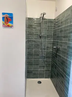a bathroom with a shower with green tile at DOLCE VITA-Calme-Vue Mer in Chiatra