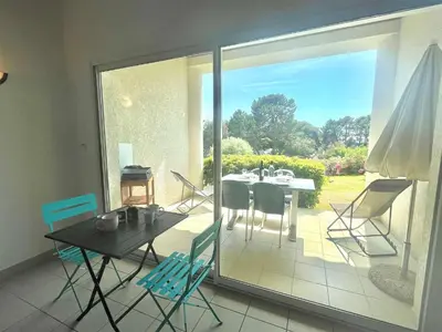a dining room with a table and chairs on a patio at Appartement Bella Vista 302 Porticcio in Porticcio