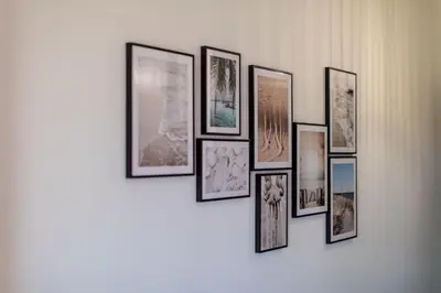 a group of framed pictures on a wall at Joséphine - Appt vue exceptionnelle Porto-Vecchio in Porto-Vecchio