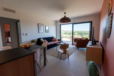 a living room with a couch and a table at Joséphine - Appt vue exceptionnelle Porto-Vecchio in Porto-Vecchio