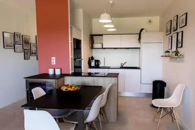 a kitchen with a table with a bowl of fruit on it at Joséphine - Appt vue exceptionnelle Porto-Vecchio in Porto-Vecchio