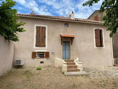 a house with stairs in front of it at Appartement sous les toits in Piana